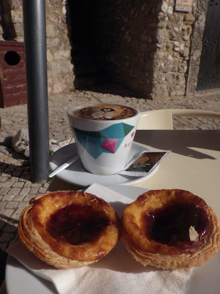 Two pastéis de nata with coffee